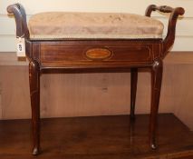 An Edwardian box seat piano stool