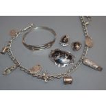 A silver charm bracelet, hung with nine charms including a Victorian locket, a 925 bangle and a