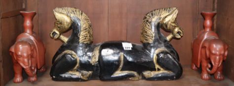 A Chinese carved wood horse group and a pair of lacquered elephant candlesticks