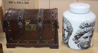 A Fornasetti style jar and cover and a small domed topped wooden chest (2)