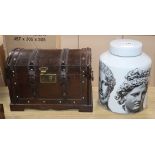 A Fornasetti style jar and cover and a small domed topped wooden chest (2)