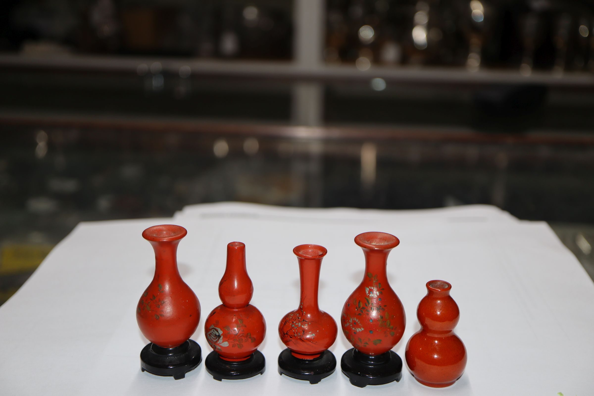 A group of four Chinese lacquer wood miniature vases and a similar pottery double gourd vase (5) - Image 2 of 7
