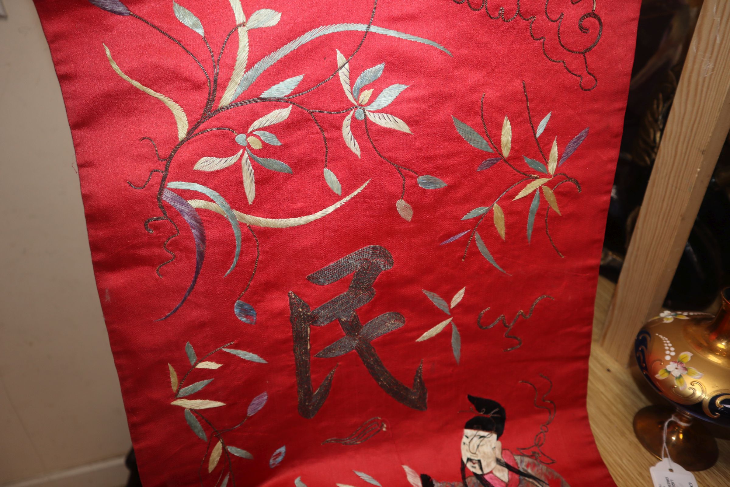 A Chinese red silk banner embroidered with figures, flowers, insects and calligraphy, on brass- - Image 3 of 7