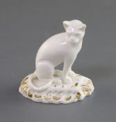 A rare Rockingham porcelain figure of a seated cat, c.1826, on a rococo gilt base, red griffin mark,