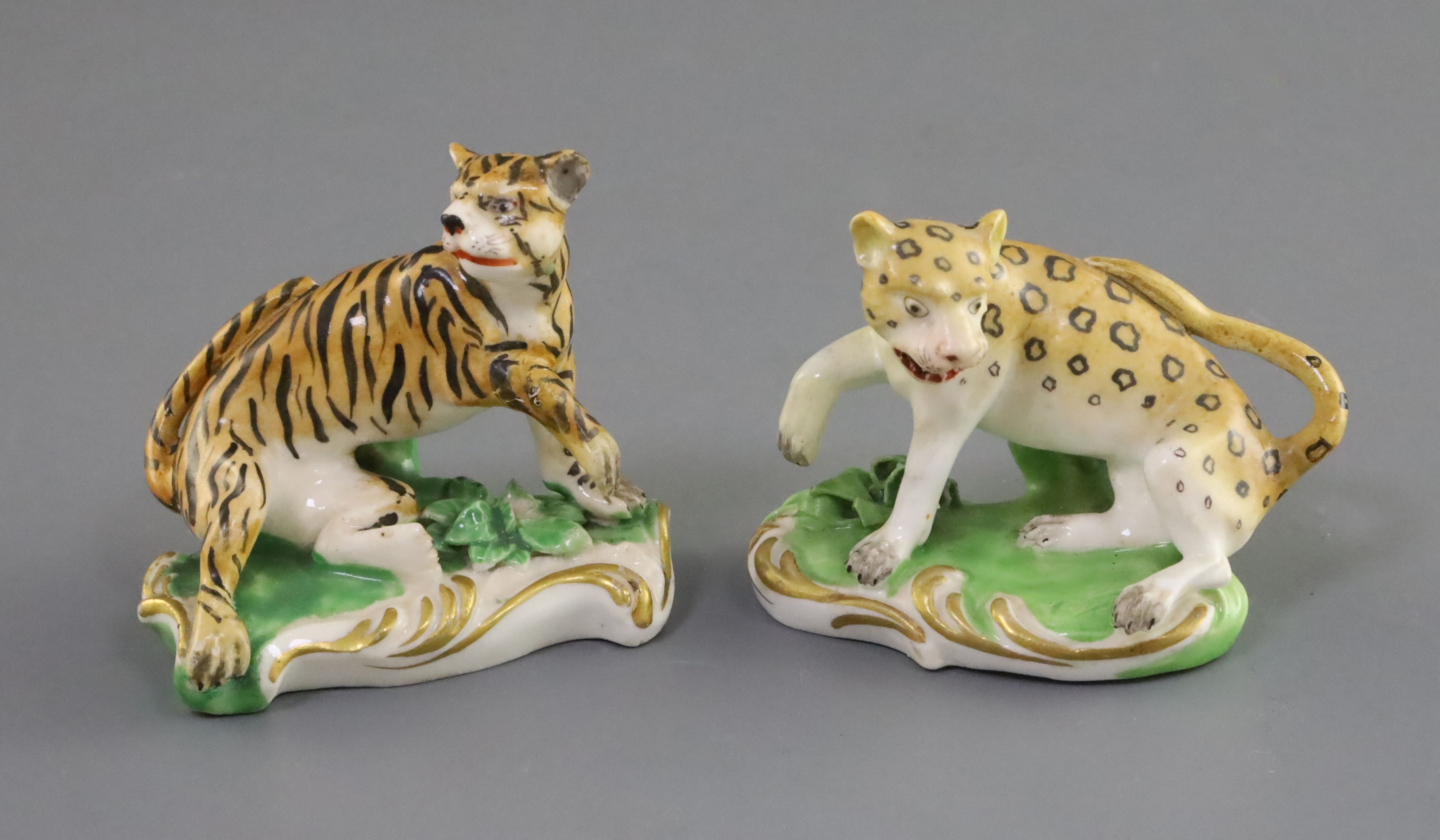 A pair of Derby porcelain figures of a tiger and a leopard, c. 1820-30, each in menacing pose on a