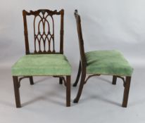 A pair of George III Gothic revival mahogany dining chairs, with Gothic pierced splats and stuff-