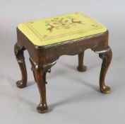 An early 18th century red walnut stool, with drop-in seat and scroll carved cabriole legs with pad