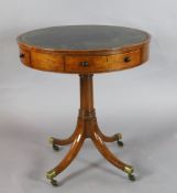 A Regency mahogany drum top occasional table, with gilt green skiver, two drawers and two side