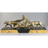 Michel Decoux (1837-1924). An Art Deco bronze group of a reclining woman with two panthers, on