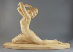 Lucien Alliot. An Art Deco carved stone figure of a naked female dancer, signed, length 28in. height