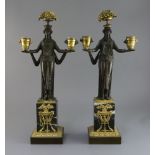 A pair of 19th century French classical revival bronze and ormolu candelabra, modelled with