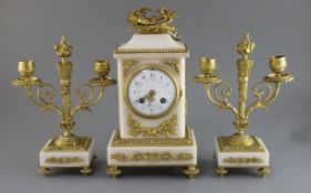 An early 20th century French ormolu and white marble clock garniture, the architectural cased