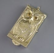 A rare early 20th century sterling silver gilt novelty compact, decorated with an owl on a perch,