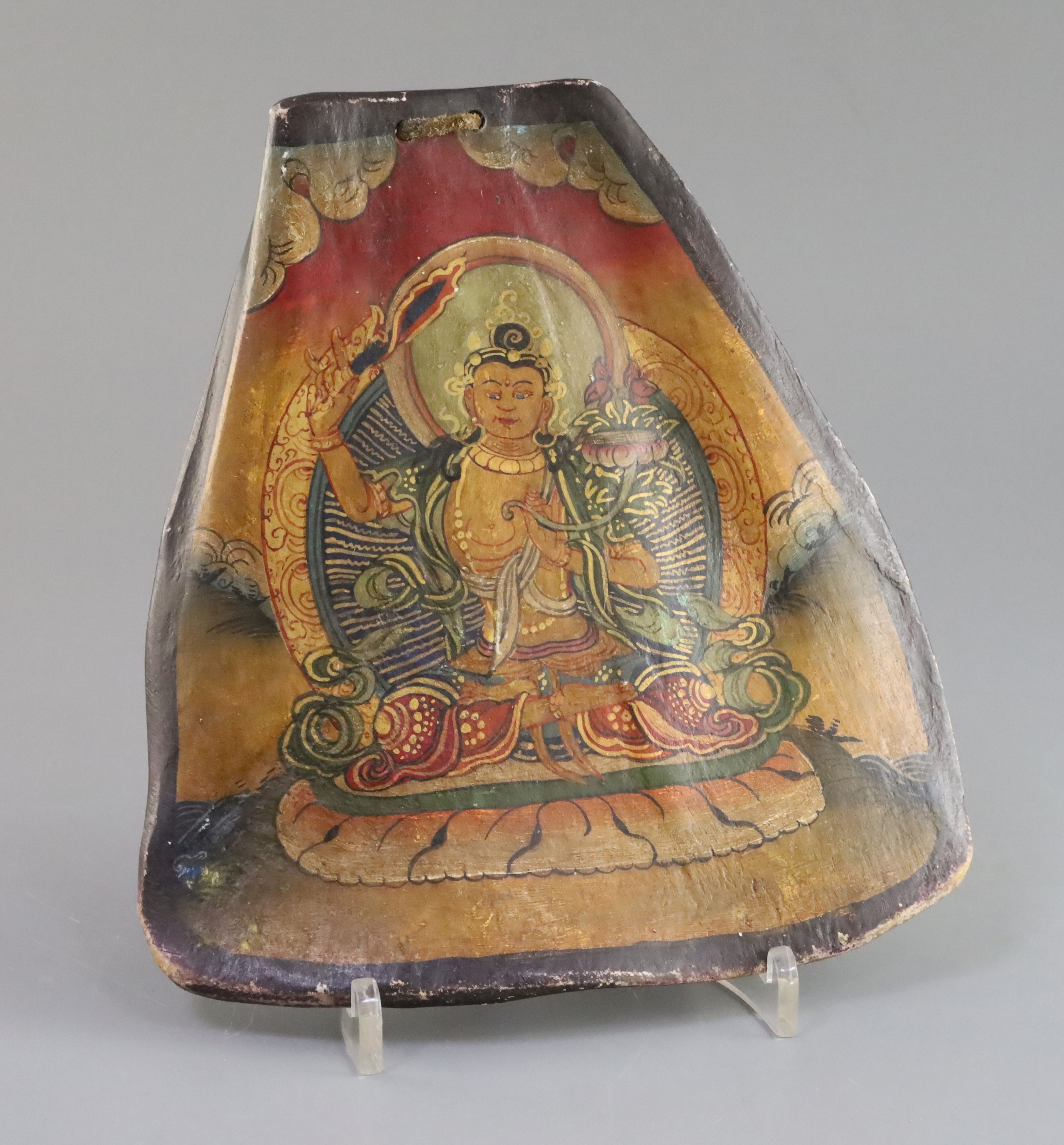 A Tibetan thangka depicting Bodhisattva painted on an ox shoulder bone, late 19th century, H. 20.