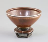 A Chinese Jian or Chayang ware bowl, Song dynasty, of rust colour with occasional black speckling