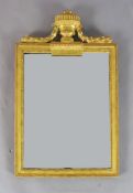 An early 19th century giltwood wall mirror, with rectangular plate and urn and laurel leaf surmount,