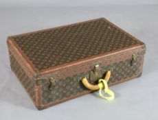 A Louis Vuitton suitcase, with brass mounted leather banded LV fabric and internal tray, no.