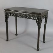 A 19th century Chinese hongmu small altar table, the frieze carved with lotus flowers and