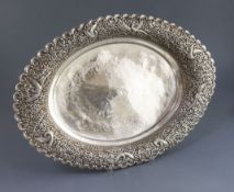 An early 20th century Indian planished silver oval fruit bowl, with pierced border decorated with