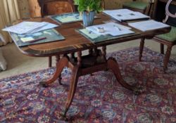 A Regency gonzalo alves banded rosewood breakfast table, with four column stem and downswept legs,