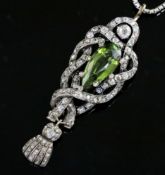 A Victorian gold and silver green tourmaline and diamond set drop pendant, of scrolling design, with