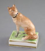 A Derby porcelain figure of a fox, c.1810-30, seated on a grassy rectangular plinth base,