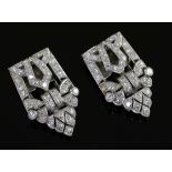 A pair of Art Deco diamond dress clips, of typical openwork geometric form, millegrain-set in