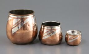 A graduated set of three Christofle Dinanderie Luc Lanel silver inset copper vases, stamped marks to