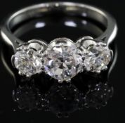 A white gold? and three stone diamond ring, the central stone weighing approximately 0.90cts, size
