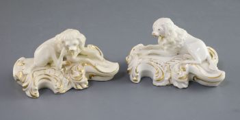 A pair of Derby porcelain figures of recumbent poodles, c.1825-45, each in gilt and white, red