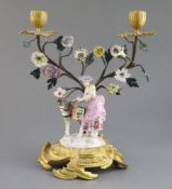 A Continental bronze and ormolu mounted porcelain group of a lady flower seller, 19th century faux
