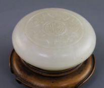 A Chinese white jade circular seal paste box, 18th/19th century, finely carved in relief with five