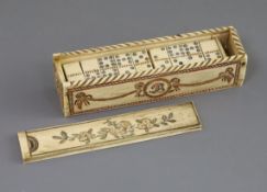 An early 19th century French Prisoner of War set of bone dominoes, with dice, in sliding lidded
