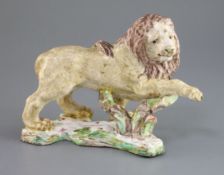 A rare and early English porcelain figure of a lion, possibly Bow, c.1750, the prancing lion with