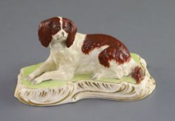 A Copeland and Garrett porcelain figure of a King Charles Spaniel, c.1833-47, recumbent on a green