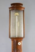 G. Lowe of Gloucester. A Regency flame mahogany bowfront stick barometer, with thermometer and