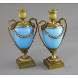A pair of 19th century French ormolu and opaque blue glass cassolets, with ram's head capped