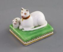 A small Chamberlain Worcester group of a recumbent white cat and kitten, c.1820-40, on a green