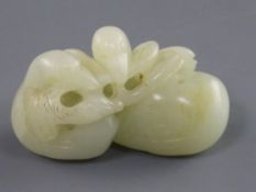 A Chinese pale celadon jade carving of two ducks biting lotus, 19th century the stone of good even