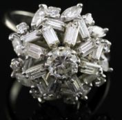 A diamond cluster ring set with brilliants, navette and baguette stones, 18ct white gold and