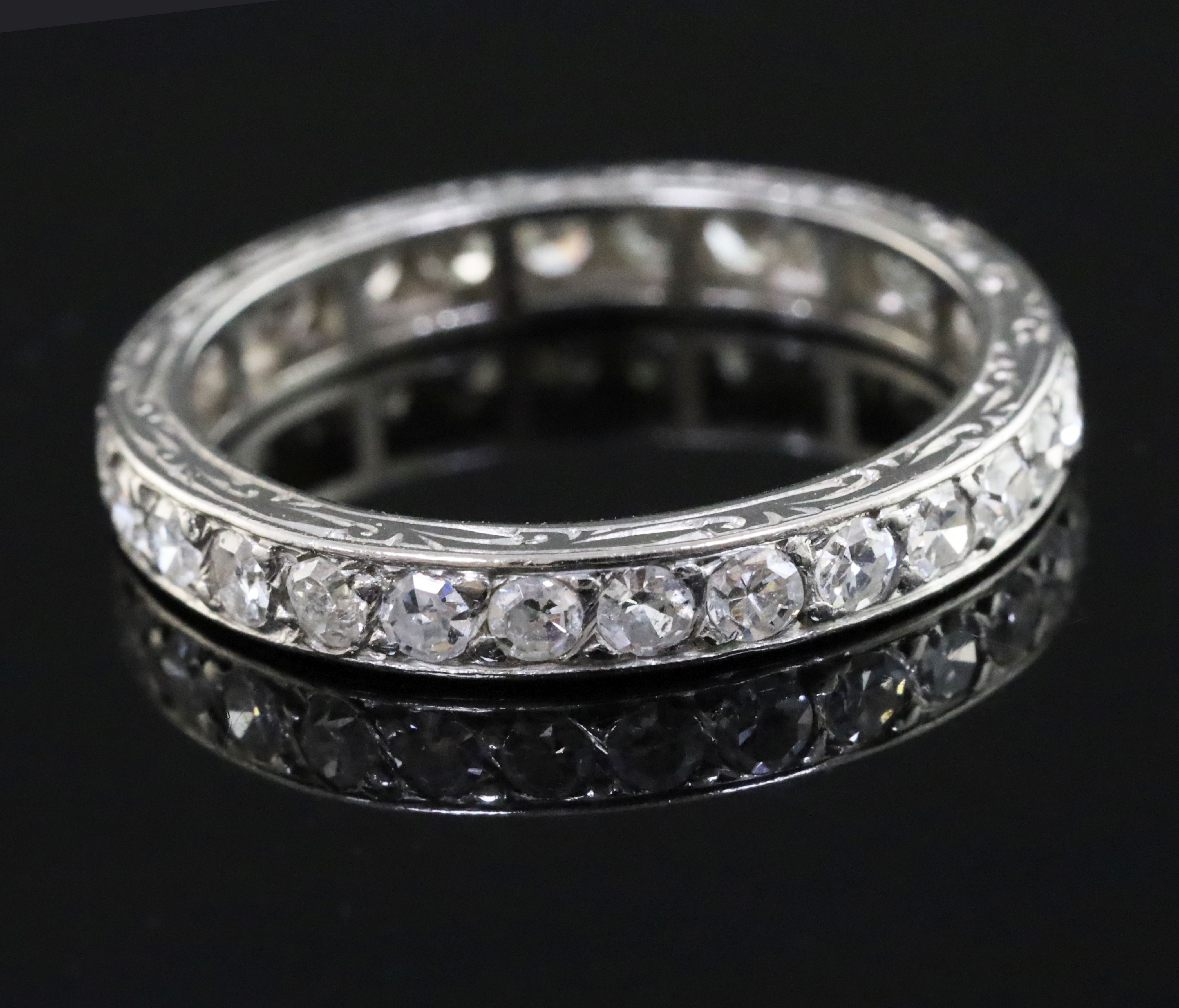 A platinum? and diamond set full eternity ring, with engraved shank and set with twenty eight