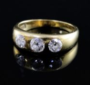 An 18ct gold and gypsy set three stone diamond ring, with a total diamond weight of approximately