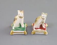 Two Rockingham porcelain toy figures of cats, c.1826-30, each seated on a cushion, unmarked, H. 3.