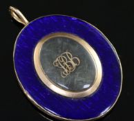 A 19th century gold and blue enamel set oval pendant, the front and verso with glazed panels and
