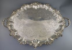 A Victorian silver two handled oval tea tray by Edward & John Barnard, with pierced floral scroll