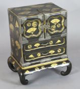 A good Japanese silver mounted gold lacquered table cabinet, Meiji period, decorated with fans and