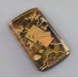 A Japanese gilt lacquered tortoiseshell cigar case, Meiji period, decorated with a boat and peonies,