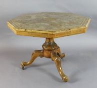 A Victorian burr walnut octagonal centre table, with tilt top and foliate carved tripod base, fitted
