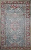 A Turkish blue ground rug, with central foliate medallion in a field of scrolling foliage and