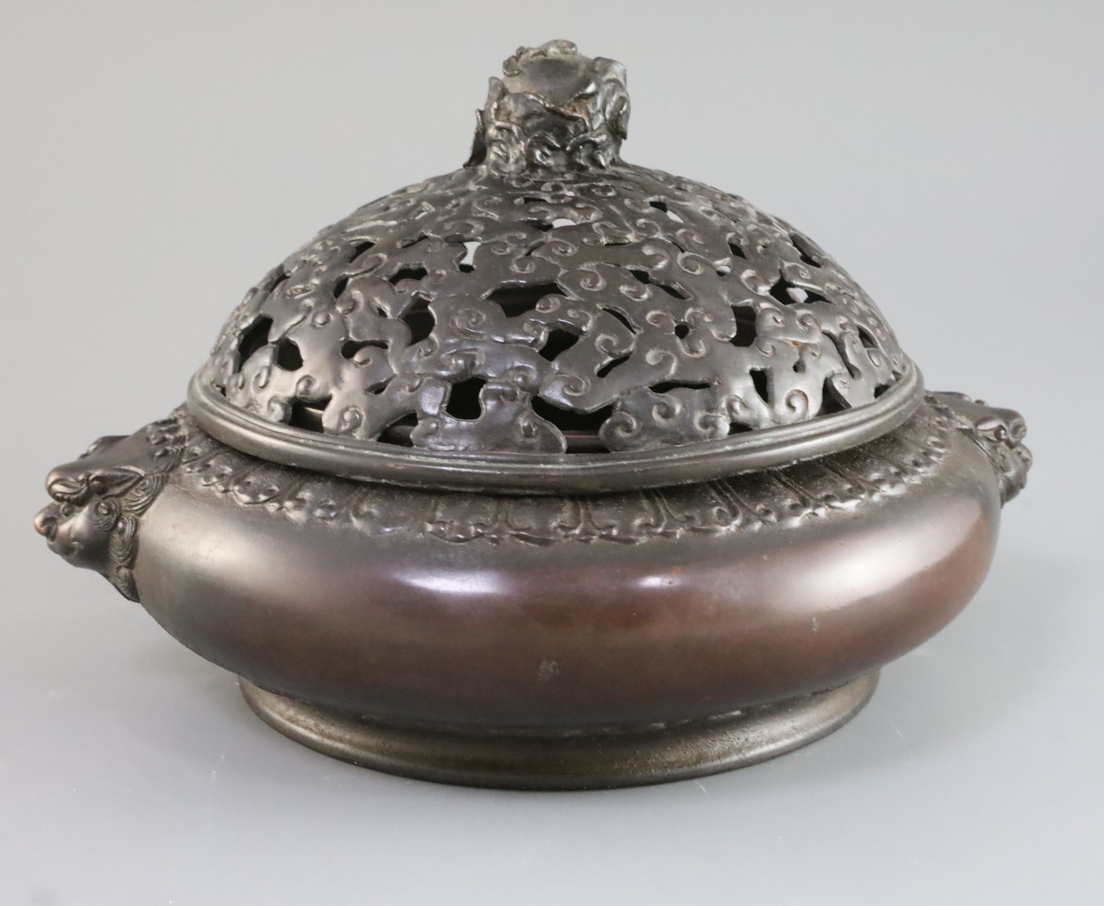 A large Chinese bronze censer, 17th/18th century with 16th/17th century bronze cover, the compressed